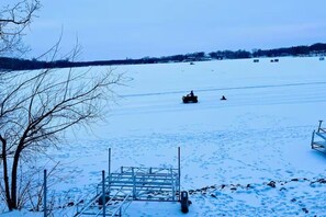 A snow-covered landscape with a metal dock structure.