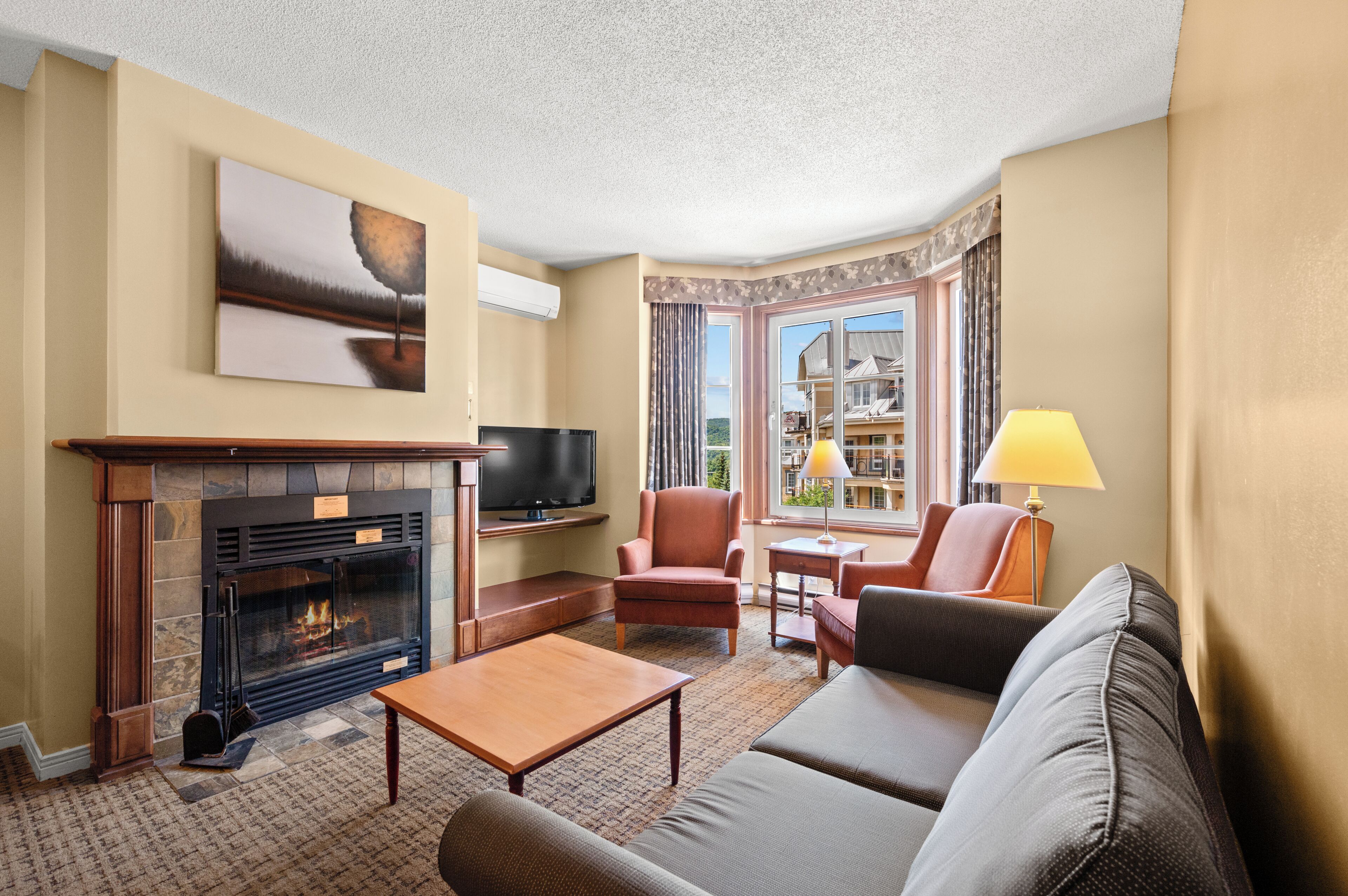 A living room with a fireplace, television, and seating area.