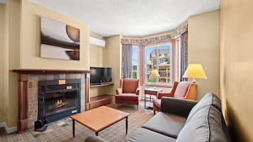 A living room with a fireplace, television, and seating area.