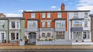 A row of terraced houses with a sign reading 'Mallow View' on the front. - Mallow View Guest House | Cleethorpes Beachside (Cleethorpes-Mallow View Guest House)
