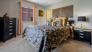 A bedroom with a bed, a dresser, a nightstand, a lamp, a window with curtains, and a wall art piece. - Toroweap- Sedona Bell Rock Views (Sedona)