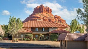 A hotel with a red-tiled roof, a balcony, and a view of a red rock formation. - Toroweap- Sedona Bell Rock Views (Sedona)