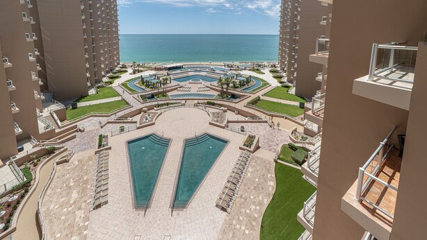A resort with multiple swimming pools, a central fountain, and a view of the ocean. - Stunning 3BR 3BA Cortez 601 @ Las Palomas Phase 2 (Puerto Peñasco)