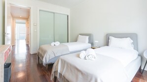 A hotel room with two beds, a desk, and a wardrobe. - La Belle Vie by Atlantic Holiday (Funchal)