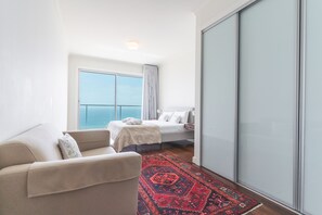 A hotel room with a bed, a sofa, a large window with a view, and a sliding door. - La Belle Vie by Atlantic Holiday (Funchal)