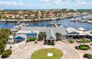 A marina with boats, a building with a dock, and a parking area. - PARADISE FOUND! Beautiful Waterfront Escape with Marina View, 3rd Floor, 1 (Punta Gorda)