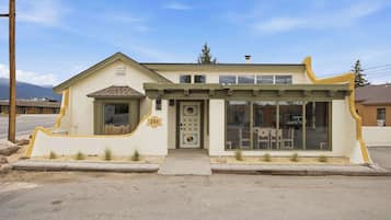 A building with a unique architectural design, a garage door, and a number '301' sign.