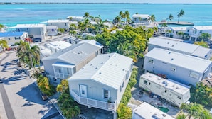 A coastal residential area with houses, RVs, and a clear view of the ocean. - 2BR, 2BA Cudjoe Key Home with pool, hot tub, and patio. (Cudjoe Key)