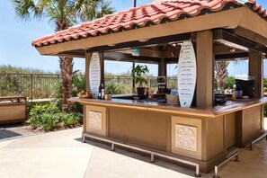 A food kiosk with a tiled roof, a menu board, and a counter. - Oceanfront Condo w/ Pools & Lazy River (North Myrtle Beach)