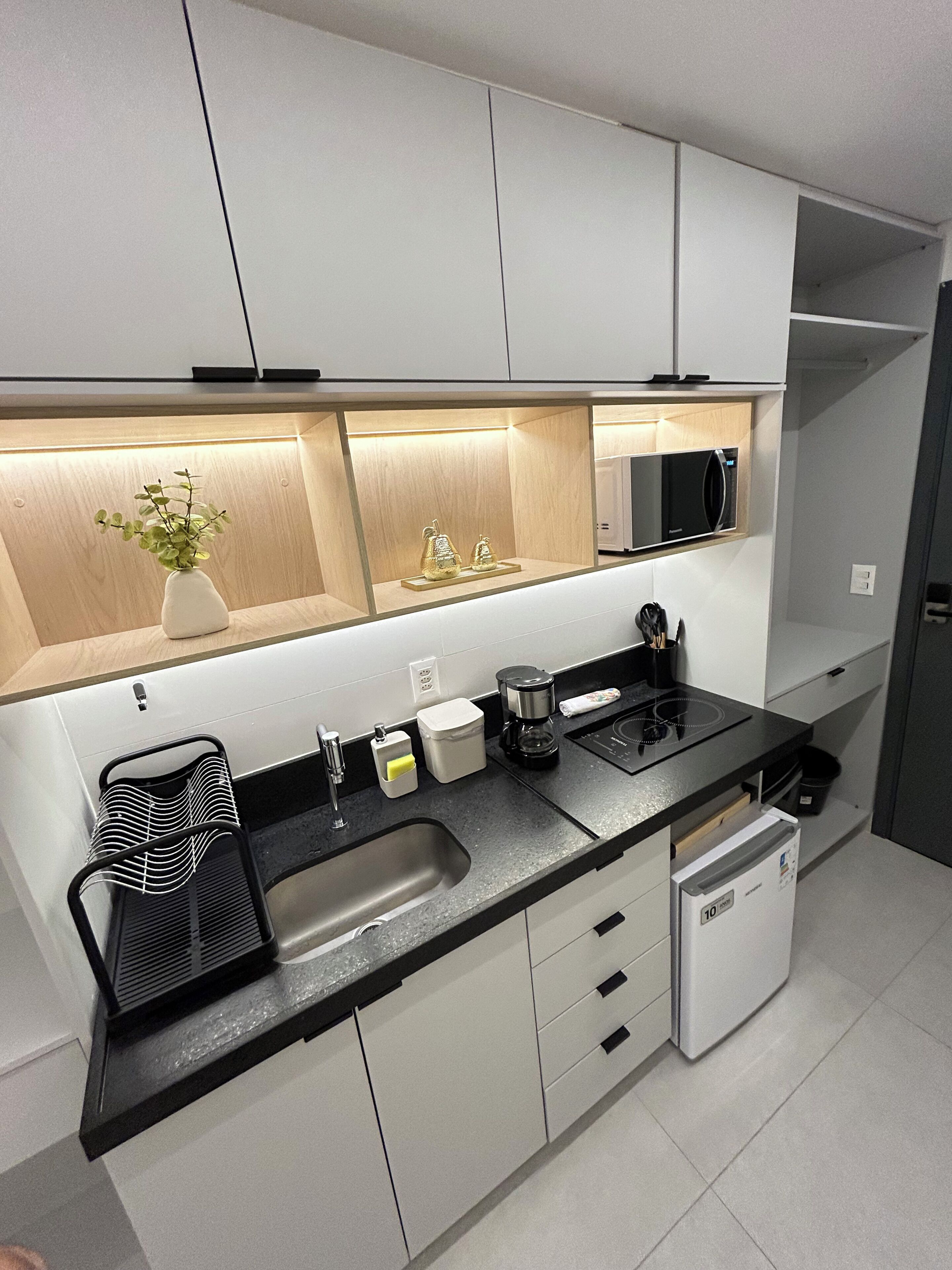 A modern kitchen with a microwave, sink, and dishwasher.