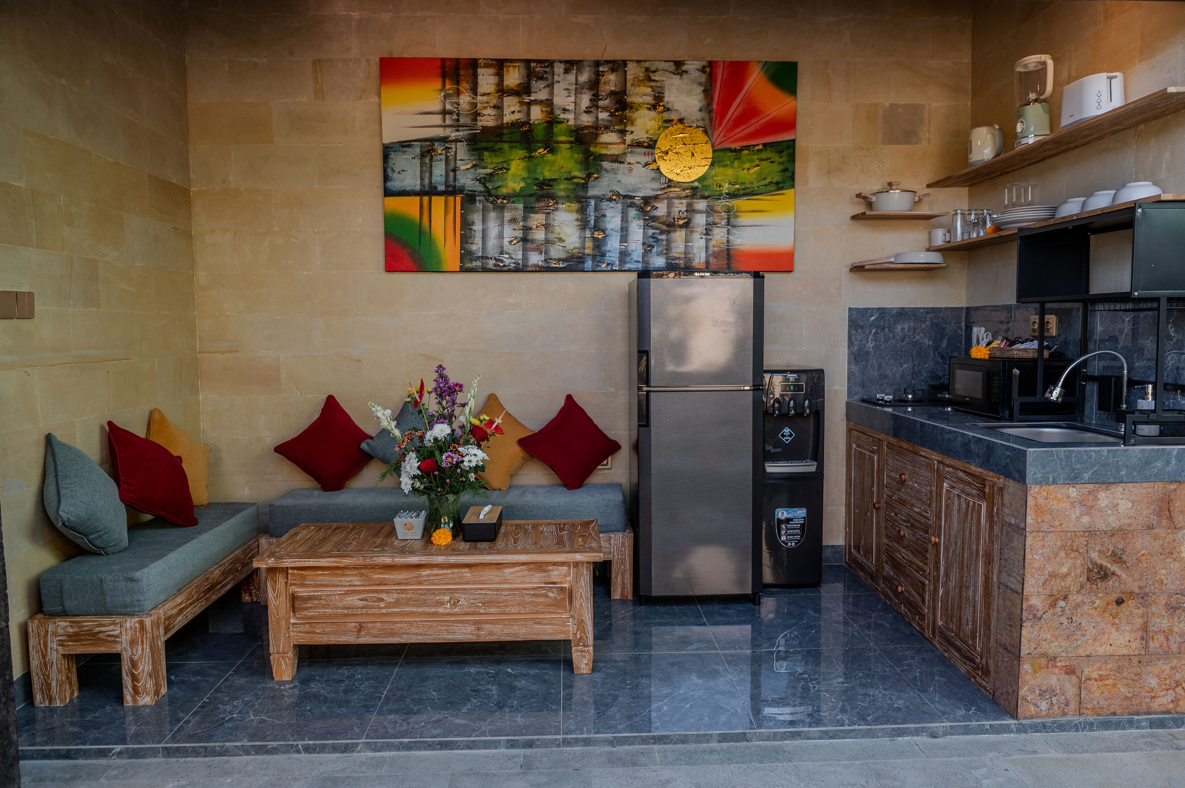 A modern kitchen with a built-in refrigerator, wooden cabinets, and a marble countertop.