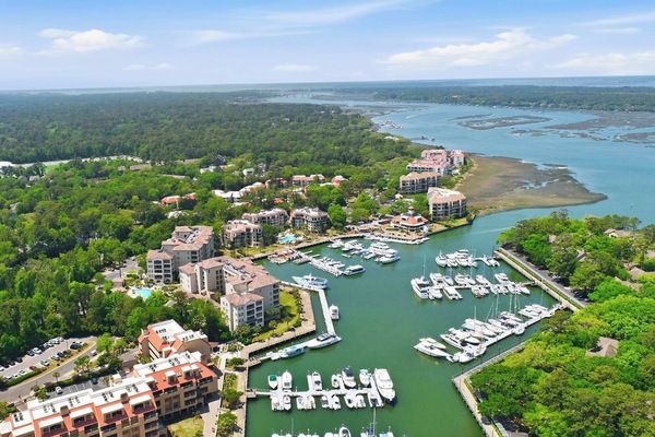 Aerial of Shelter Cove Harbour - your home base for boating, dolphin tours, sunset cruises, and waterfront dining.