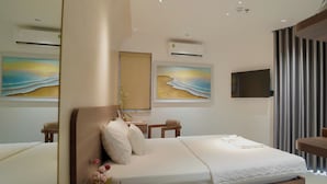 A modern bedroom with a bed, bedside tables, a mirror, wall art, and an air conditioning unit. - Aries Boutique Hotel Vung Tau (Ho Chi Minh City)