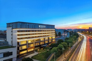A modern hotel with a flat roof, multiple floors, and a prominent sign. - Licheng Borui Hotel (Guangzhou)