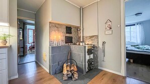 A modern kitchen with a stone backsplash, a built-in stove, and a wooden floor. - 2 bedroom cozy home in Tingsryd (Tingsryd)