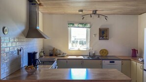 A kitchen with a wooden countertop, a window with a view, a sink, and cabinets. - 3 bedroom stunning home in Mörbylånga (Mörbylånga)