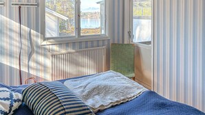 A bedroom with a bed, a window, and a radiator. - Gorgeous home in Värmdö (Värmdö)