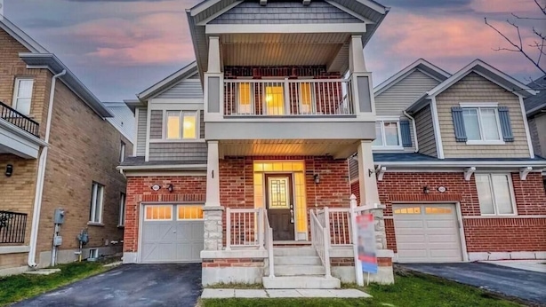 A two-story residential building with a front porch, a garage, and a brick facade. - Spacious, Private & Independent Stay in Milton (Milton)