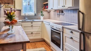 A kitchen with a wooden countertop, a sink, a stove, and cabinets. - Nice home in Alingsås (Alingsås)