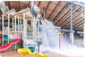 A water play area with slides and water jets, enclosed by a metal roof structure. - Family-Friendly 4BR Near Big Boulder w Lake & Mountain Access + Fireplace + Pets (Lake Harmony)