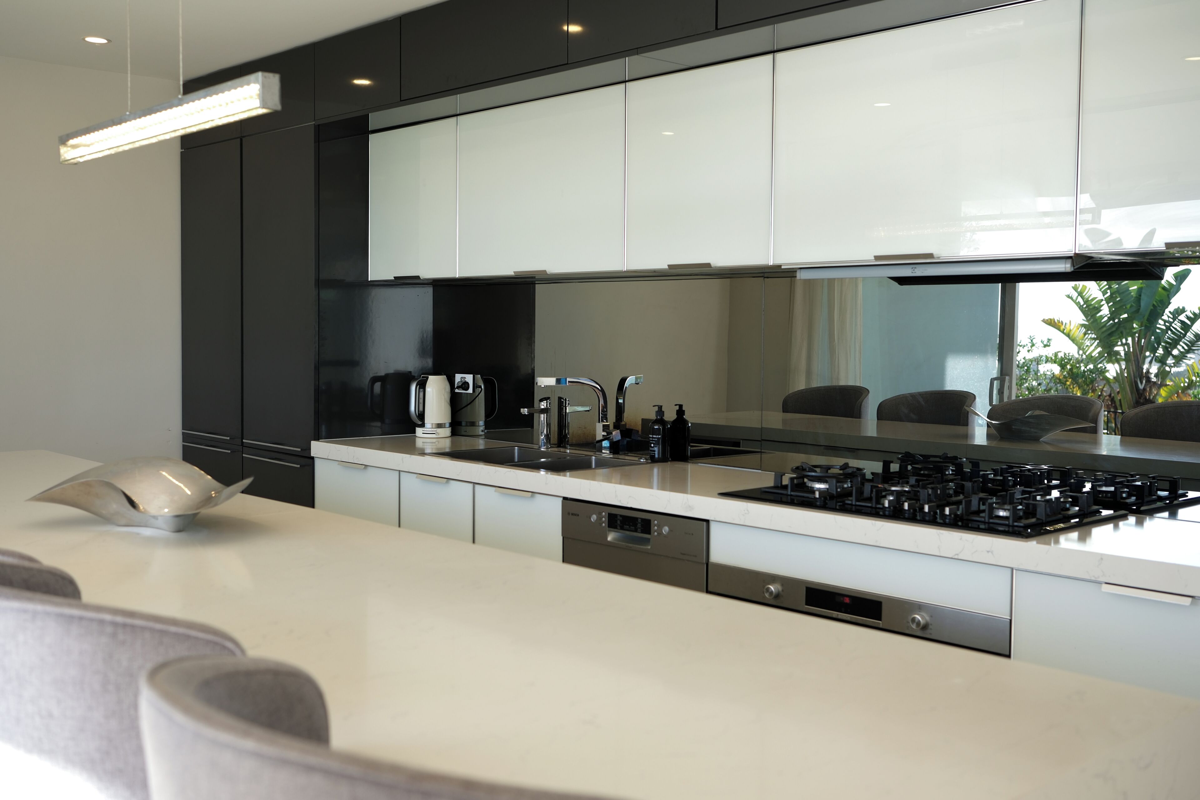 A modern kitchen with a central island, stainless steel appliances, and a sleek design.