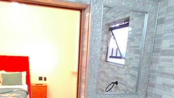 A bathroom with a sink, mirror, and tiled walls.