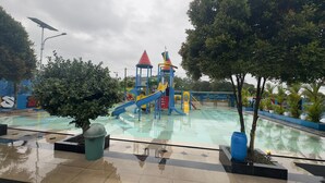 A water park with a play structure, a pool, and surrounding greenery. - Gorgeous 3-bedroom villa in cool Wonosobo for relaxing stays (Wonosobo)