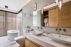 A modern bathroom with a freestanding bathtub, two sinks, and a large mirror. - Villa Fanta Sea (Koh Samui)