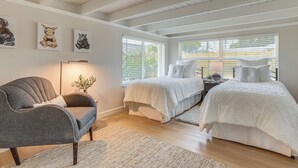 A bedroom with two beds, a chair, and artwork on the wall. - Completedly Renovated Pool: Home Minutes to Beach! (North Palm Beach)