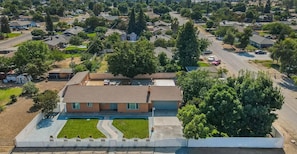 A residential area with houses, a swimming pool, and a fenced yard.