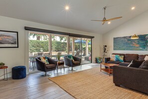 A spacious living room with a large window, a ceiling fan, and a painting on the wall. - 1 Mi to Dtwn Palm Springs! Desert Escape w/ Pool (Palm Springs)
