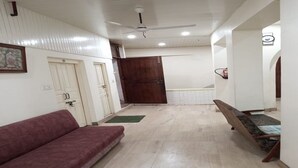 A room with a sofa, a bed, a ceiling fan, and a door. - SAH HAVELI 400m WALK TO KASHI VISHWANATH (Varanasi)