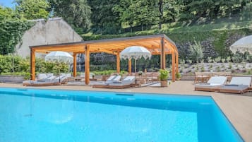 Seasonal outdoor pool, open 11:00 AM to 8:00 PM, pool umbrellas