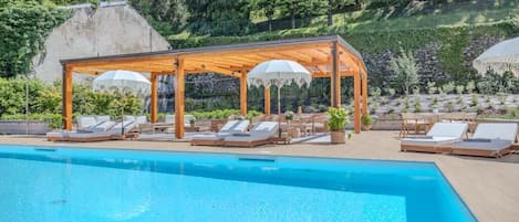 Seasonal outdoor pool, open 11:00 AM to 8:00 PM, pool umbrellas