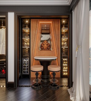 A room with a central table, two chairs, a decorative wall piece, and shelves with items. - Orient Legacy Cruise (Tuan Chau)