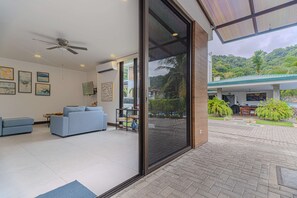Ein modernes Wohnzimmer mit einer Couch, einem Couchtisch und einem Deckenventilator.