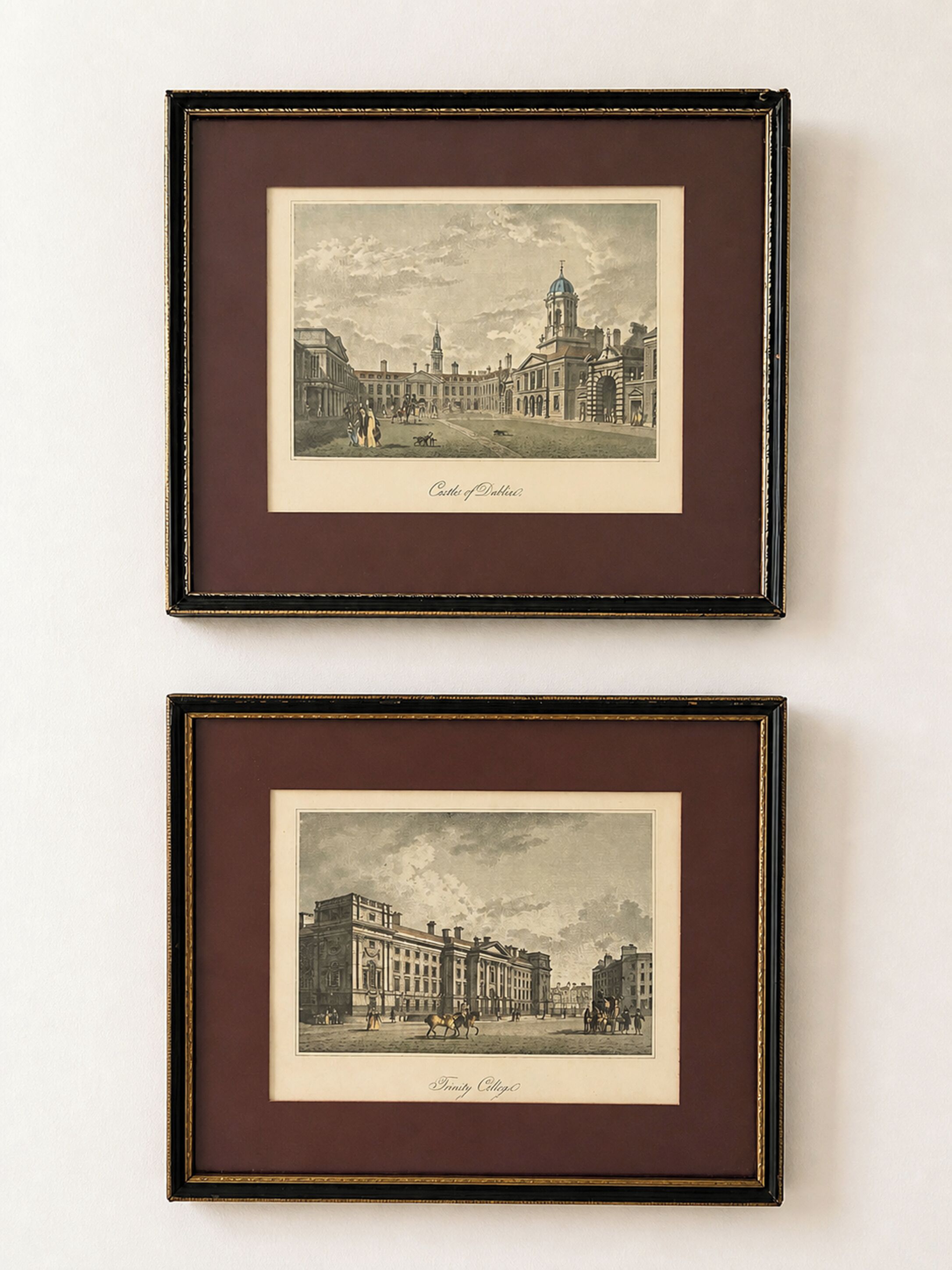 Two framed black and white historical cityscape prints, titled 'Castles of Dublin' and 'Trinity College,' with architectural details and figures.