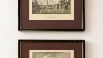 Two framed black and white historical cityscape prints, titled 'Castles of Dublin' and 'Trinity College,' with architectural details and figures.