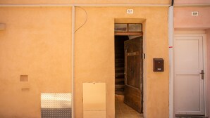 A building entrance with a door marked '57' and a white door marked '59' to the right. - 'O'soleil' Apartment with Wi-Fi and Air Conditioning (Fréjus)