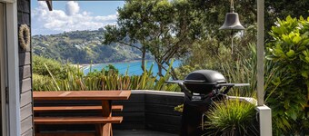 The Point - Onetangi. Luxury & Ocean Views - The Point is a private, light-filled home above Onetangi Beach with wide north-facing sea views. Surrounded by native bush, it offers a peaceful, secluded stay. Open-plan living includes a well-equipped ki