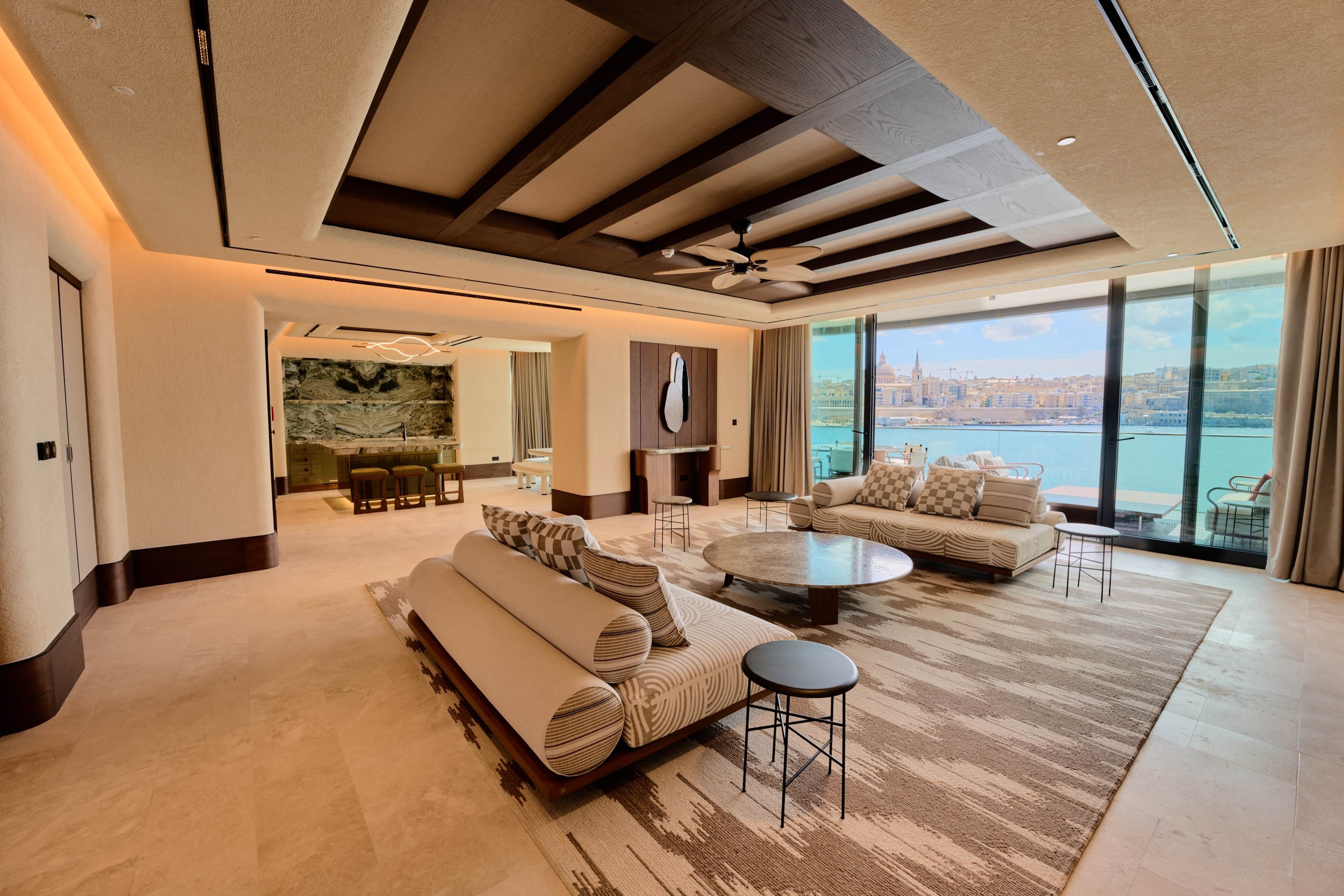 Spacious living area with sea views and floor-to-ceiling windows.