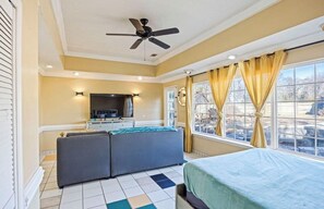 A bedroom with a bed, a sofa, a TV, and a window with curtains. - Master’s Magic Retreat-2 Bedrooms-Augusta Regional Airport-Feels Like Home (Augusta)