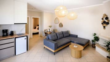 Deluxe Apartment | Living area | 40-inch LCD TV with cable channels