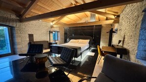 Une chambre à coucher moderne avec un lit, une table en verre et une chaise.