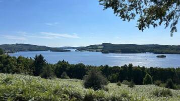 A lake surrounded by forested hills.