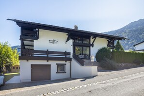 A chalet with a sign reading 'Chalet Bodenschatz,' a wooden balcony, and a mountain backdrop. - Chalet Suite with Breakfast, Mountain Views & Private Terrace (Vandans)