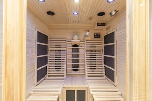 A sauna with wooden walls and benches, a control panel, and a ventilation system. - Double Room with Breakfast, Balcony and Mountain View (Vandans)