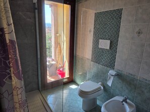 A bathroom with a toilet, bidet, and shower area. - Charming Apartment in La Maddalena With Private Terrace (Capoterra)