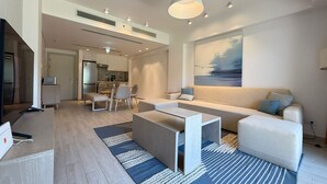 A modern living room with a sofa, coffee table, and a painting on the wall. - Fouka North Coast SA-2B-B02 (Marsa Matrouh)