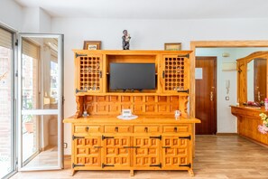 A wooden entertainment center with a flat-screen TV, multiple drawers, and a small figurine on top. - Apartment 'Famacosta' with Balcony (Benidorm)